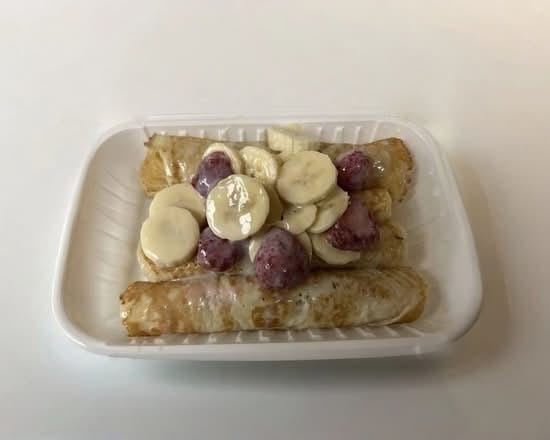 Strawberry Banana Topped Stuffed Crêpes.